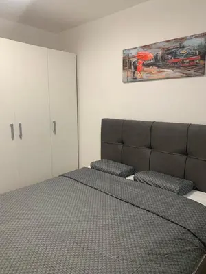 a bedroom with a bed and cabinets and a picture at Stan na dan Gradiška in Bosanska Gradiška