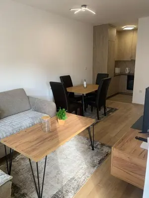a living room with a couch and a table and chairs at Stan na dan Gradiška in Bosanska Gradiška
