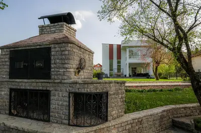 a brick fireplace in front of a building at Villa Rio Verde in Bihać