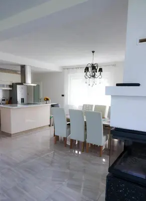 a kitchen and dining room with a table and chairs at Villa Rio Verde in Bihać