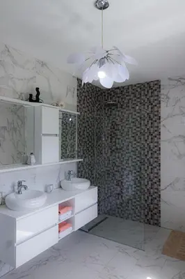 a bathroom with two sinks and a glass shower at Villa Rio Verde in Bihać
