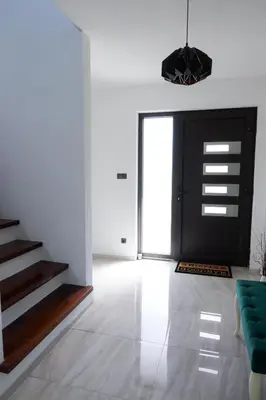 a living room with a black door and a green couch at Villa Rio Verde in Bihać