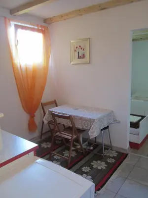 a table and chairs in a room with a window at Bravo Guest House in Bihać