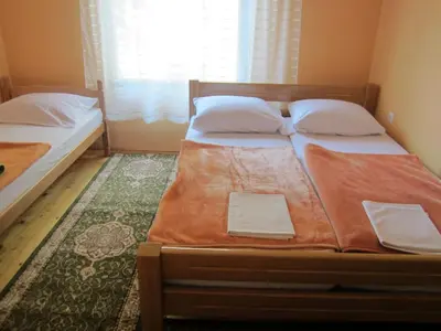 a bedroom with two beds and a window at Bravo Guest House in Bihać