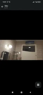a picture of a bathroom with a door and a tile floor at Sofi in Rebrovac