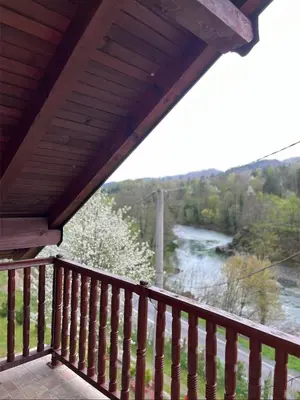 a balcony with a view of a river at Vikendica Krivaja sa bazenom i privatnom plažom in Zavidovići