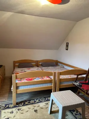 a bedroom with two bunk beds in a attic at Vikendica Krivaja sa bazenom i privatnom plažom in Zavidovići