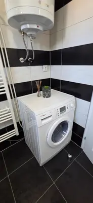 a washer and dryer in a bathroom with a sink at Apartman STARI GRAD in Bihać