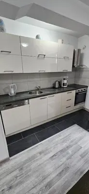 a kitchen with white cabinets and a sink at Apartman STARI GRAD in Bihać
