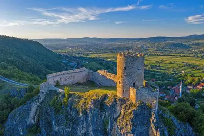 a castle on top of a cliff on a mountain at Apartman STARI GRAD in Bihać