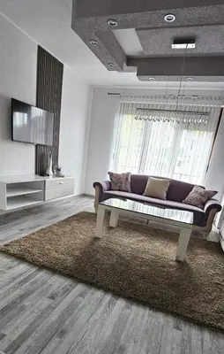 a living room with a couch and a television at Apartman STARI GRAD in Bihać