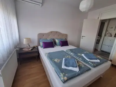 a bedroom with a large bed with purple pillows at Esma 2 in Bihać