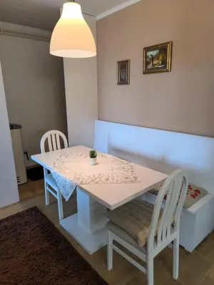 a white table and chairs in a room with a lamp at Esma 2 in Bihać