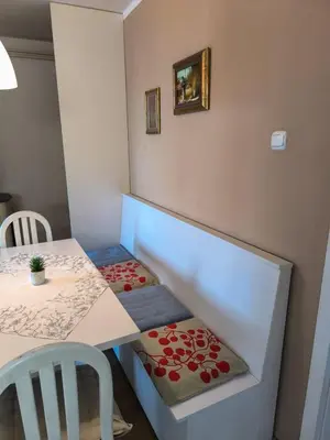 a small room with a table and a staircase with a bench at Esma 2 in Bihać