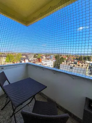 a balcony with a table and two chairs and a window at Esma 2 in Bihać
