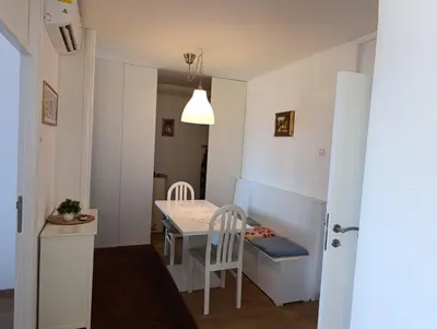 a small apartment with a small table and chairs at Esma 2 in Bihać