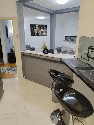 a salon with two black stools at a counter at Lena Exclusive in Bihać