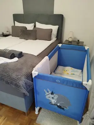 a bedroom with two beds and a blue dresser at Lena Exclusive in Bihać