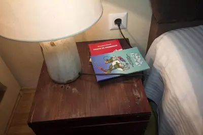 two books on a table next to a bed at Apartment Barby - Deluxe in Banja Luka