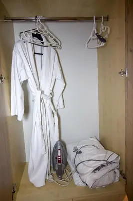 a room with a bed with a white robe and a helmet at Apartment Barby - Deluxe in Banja Luka