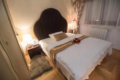 a bedroom with a large bed with areath on it at Apartment Barby - Deluxe in Banja Luka