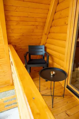 a room with a table and a chair in a cabin at Cottage NIKA2 in Jajce