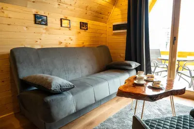 a living room with a couch and a table at Cottage NIKA2 in Jajce