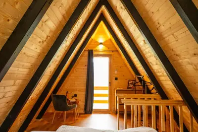 a room in a log cabin with a large window at Cottage NIKA2 in Jajce