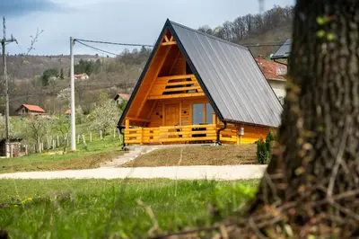 a large wooden cabin with a metal roof at Cottage NIKA2 in Jajce