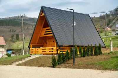 a large wooden cabin with a metal roof at Cottage NIKA2 in Jajce