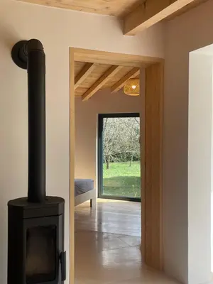 a living room with a black stove in a room at The River House in Lohovo