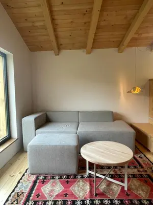 a living room with a couch and a table at The River House in Lohovo