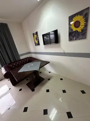 a living room with a couch and a table at Studio Apartman Orhideja in Sanski most