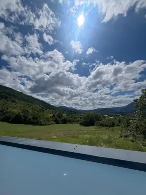 a view of a field with the sun in the sky at Melissa luxury Apartment in Bijelo Brdo