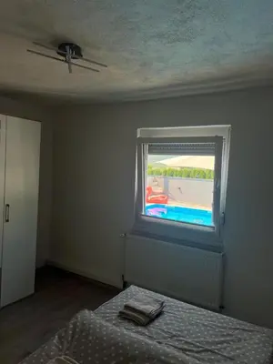 a bedroom with a bed and a window at Melissa luxury Apartment in Bijelo Brdo