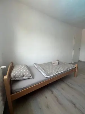 a bed in a corner of a room at Melissa luxury Apartment in Bijelo Brdo