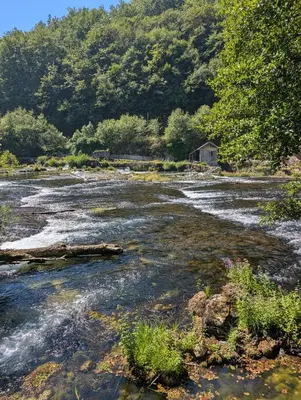 a river with a house in the middle of it at Melissa luxury Apartment in Bijelo Brdo