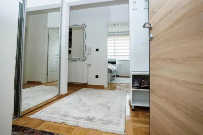 a room with a mirror and a white rug at Apartman Luxury Kiseljak in Kiseljak