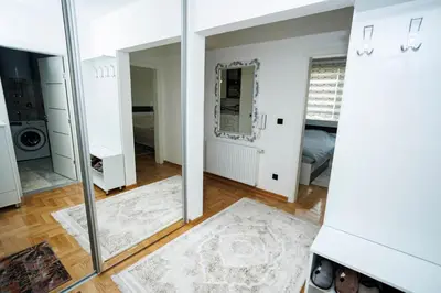 a large mirror in a room with a bedroom at Apartman Luxury Kiseljak in Kiseljak