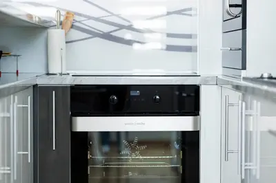 a kitchen with a black and white oven at Apartman Luxury Kiseljak in Kiseljak