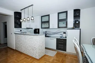 a kitchen with white cabinets and a counter top at Apartman Luxury Kiseljak in Kiseljak