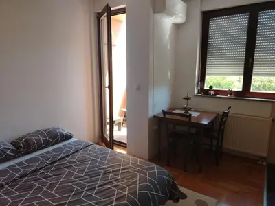a bedroom with a desk and a bed and a table at Studio D&N in Starčevica
