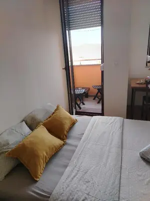 a bedroom with a bed with two pillows on it at Studio D&N in Starčevica