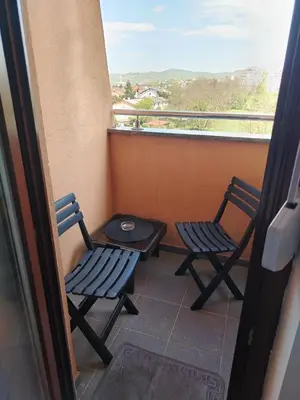 two chairs and a table on a balcony with a view at Studio D&N in Starčevica