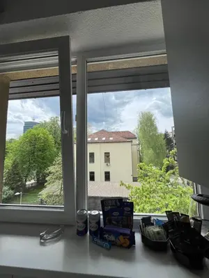 a kitchen counter with a window with a view of a building at Dora Apartman in Banja Luka