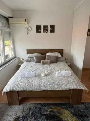 a bedroom with a bed with two towels on it at Dora Apartman in Banja Luka