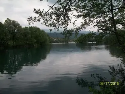 a view of a large river with trees in the background at Apartman Iman in Bihać