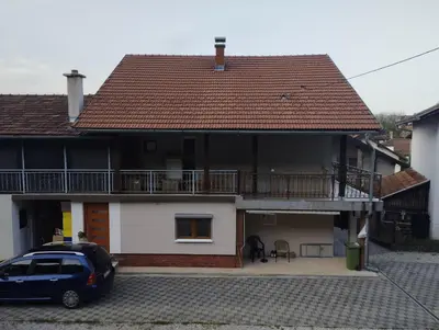 a car parked in front of a house with a balcony at Apartman Iman in Bihać