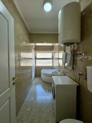 a bathroom with a toilet and a sink and a tub at Apartman 21 Lux in Banja Luka