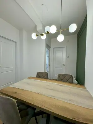 a dining room with a table and two chairs at Apartman 21 Lux in Banja Luka